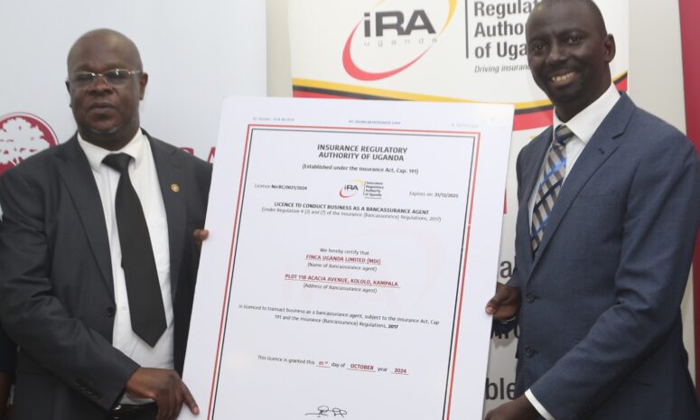 FINCA Uganda Managing Director James Onyutta and Benerd Obel, Director for Supervision, Insurance Regulatory Authority of Uganda hold poster-sized replica of FINCA Uganda's bancassurance license.