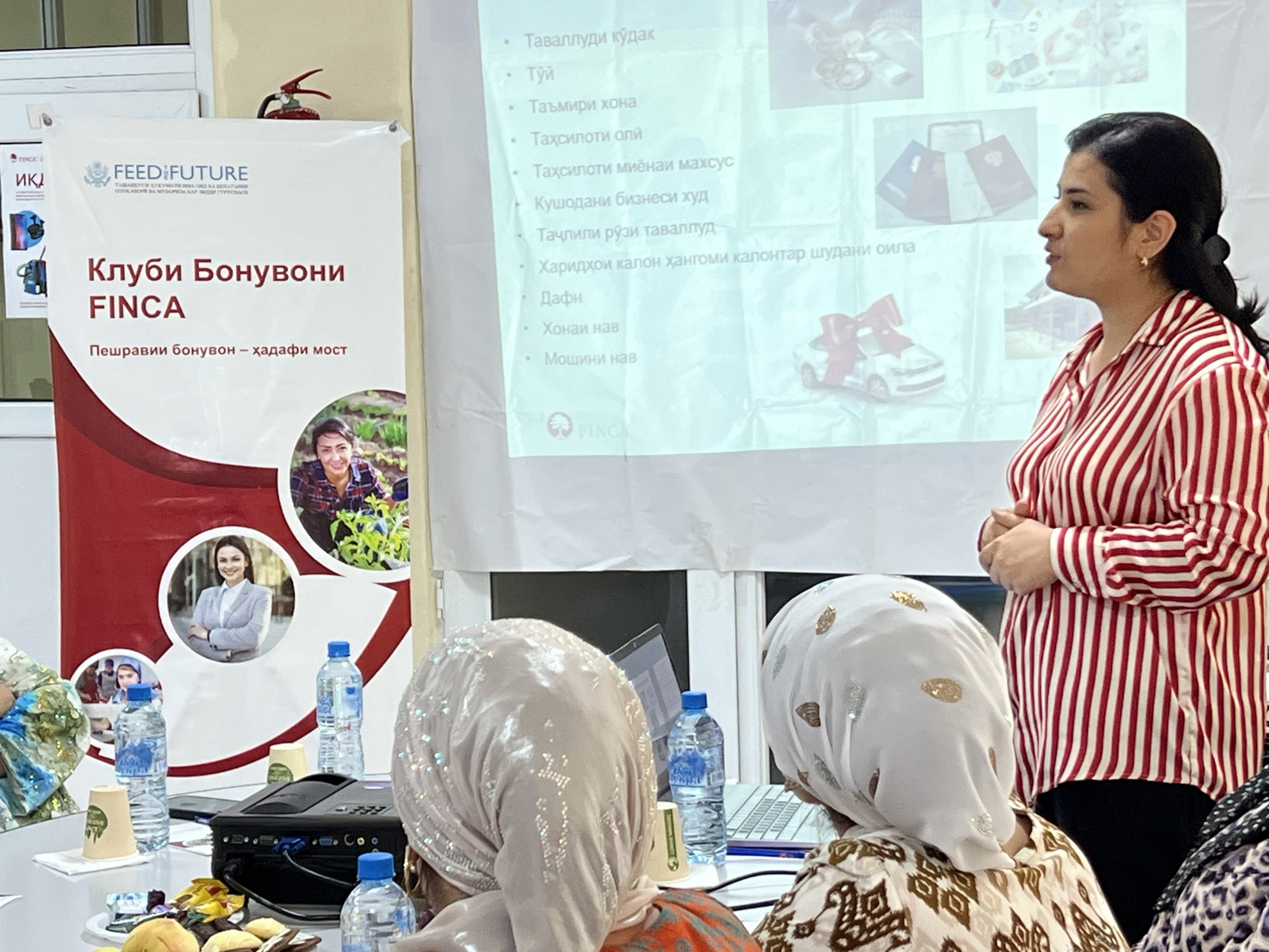 Women's Club members attending a training and listening to a speaker.